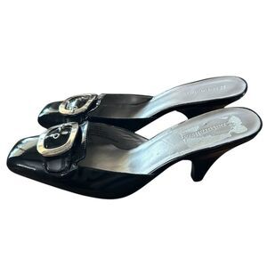 Naturalizer size 10 slip-on black mules with patent leather and a buckle accent.